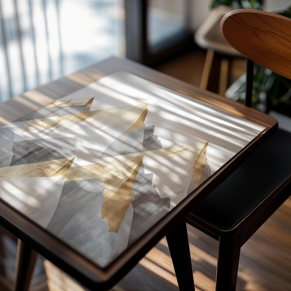 Abstract art print of gold and gray mountains on a white background, as a premium aluminum metal print from GoMetalPrint.
