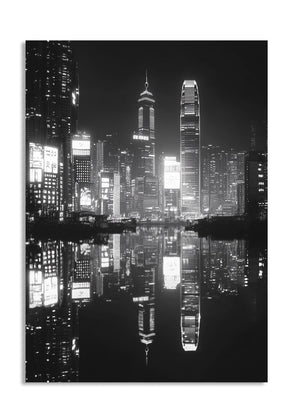 Black and white cityscape at night with reflective water, as a premium aluminum metal print from GoMetalPrint.
