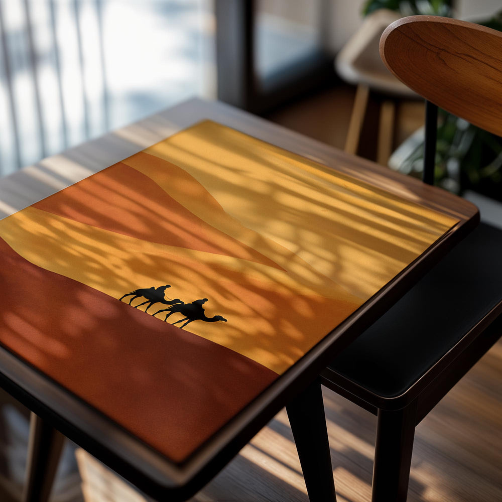 Silhouette of two people on camels against a desert landscape with orange and brown hues, as a premium aluminum metal print from GoMetalPrint.
