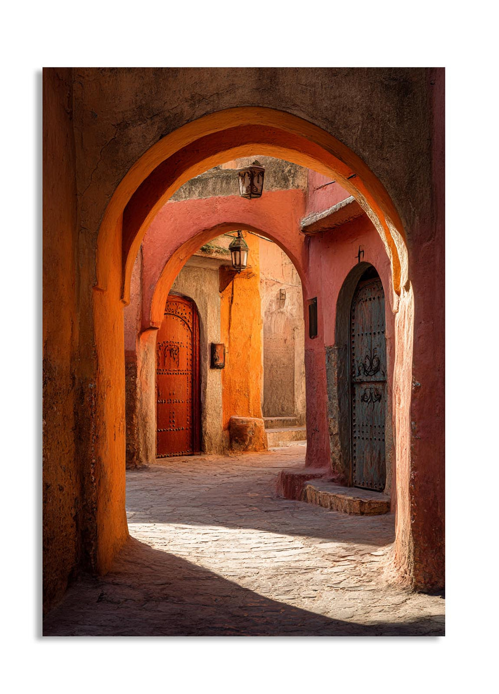 Arched entrance to a sunlit alleyway with traditional architecture, as a premium aluminum metal print from GoMetalPrint.
