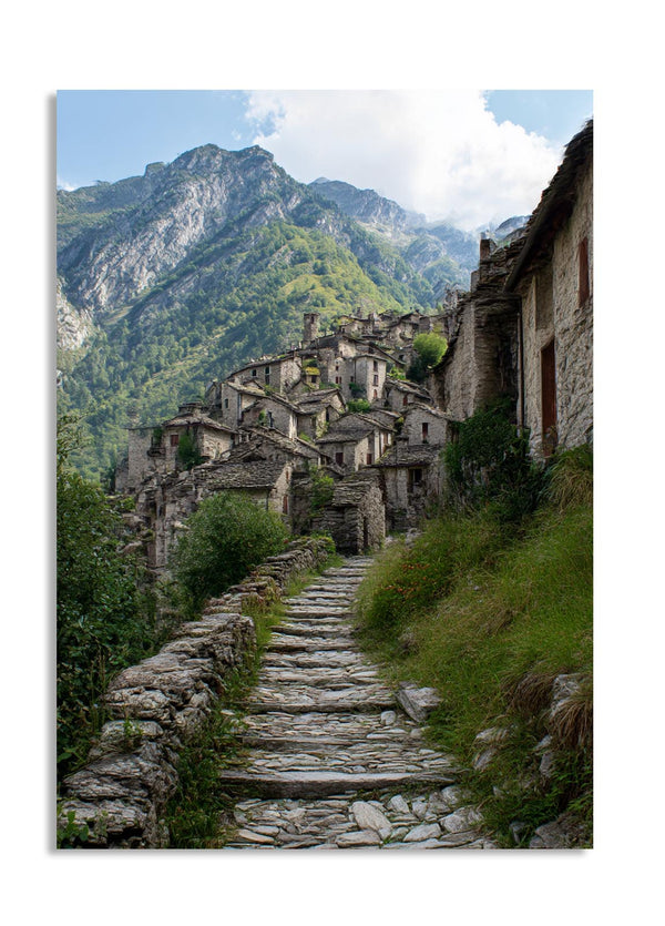 Stone path leading to an old village with mountains in the background, as a premium aluminum metal print from GoMetalPrint.

