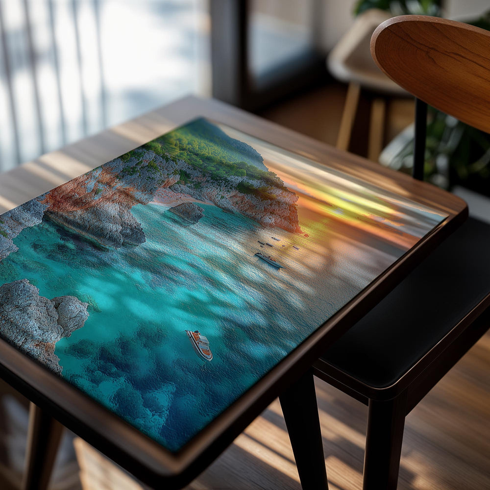 Sunset over a coastal landscape with rocky cliffs and clear blue water, as a premium aluminum metal print from GoMetalPrint.
