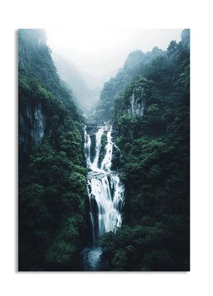 Waterfall in a lush green forest with misty atmosphere, as a premium aluminum metal print from GoMetalPrint.
