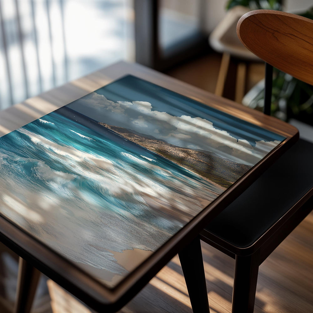 Coastal scene with blue ocean waves crashing onto a sandy beach, mountains in the background, as a premium aluminum metal print from GoMetalPrint.
