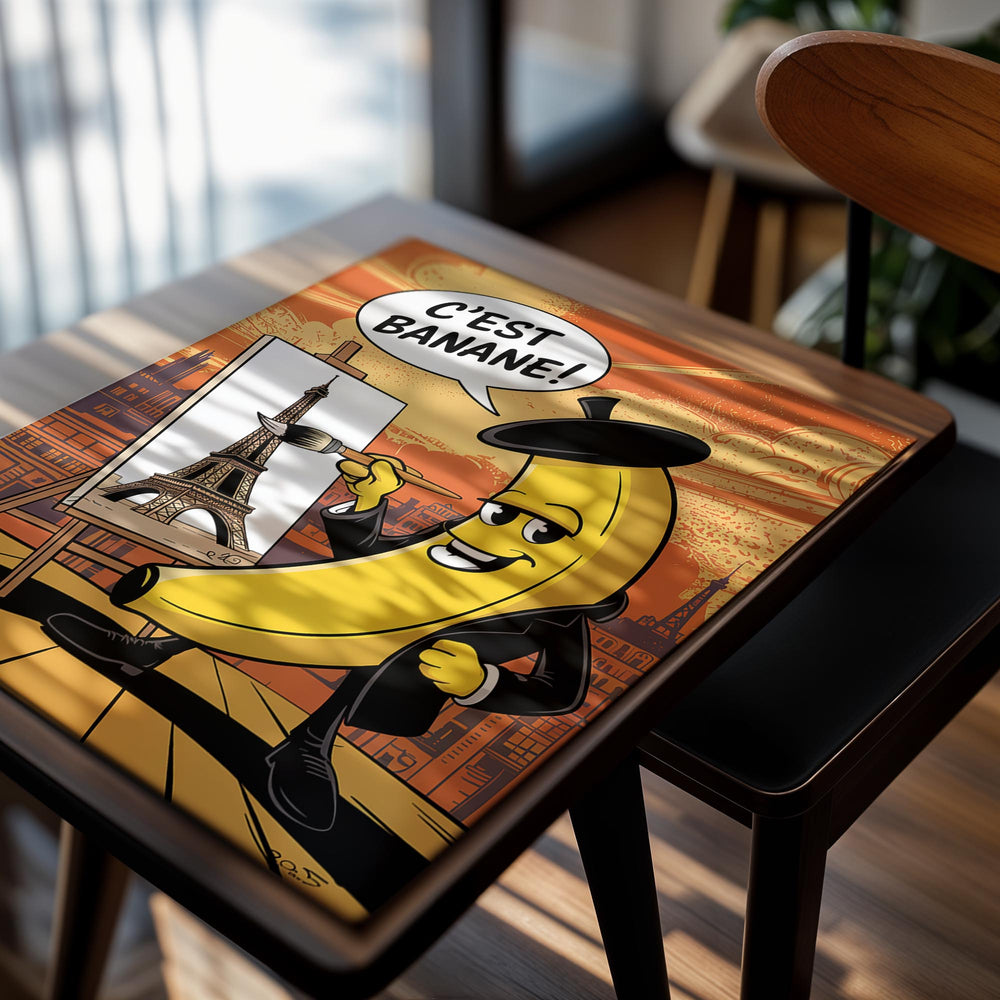 Cartoon banana character in a suit painting the Eiffel Tower with a speech bubble saying 'C'est Banane!' on an orange background, as a premium aluminum metal print from GoMetalPrint.
